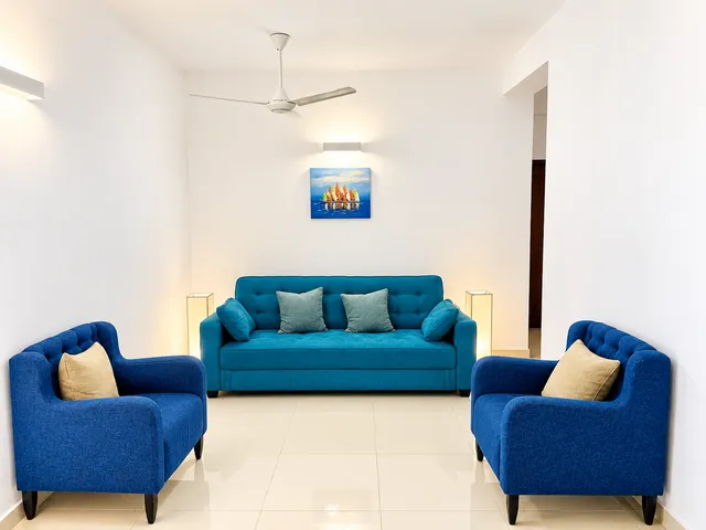 Blue sofa and armchairs in the apartment living room