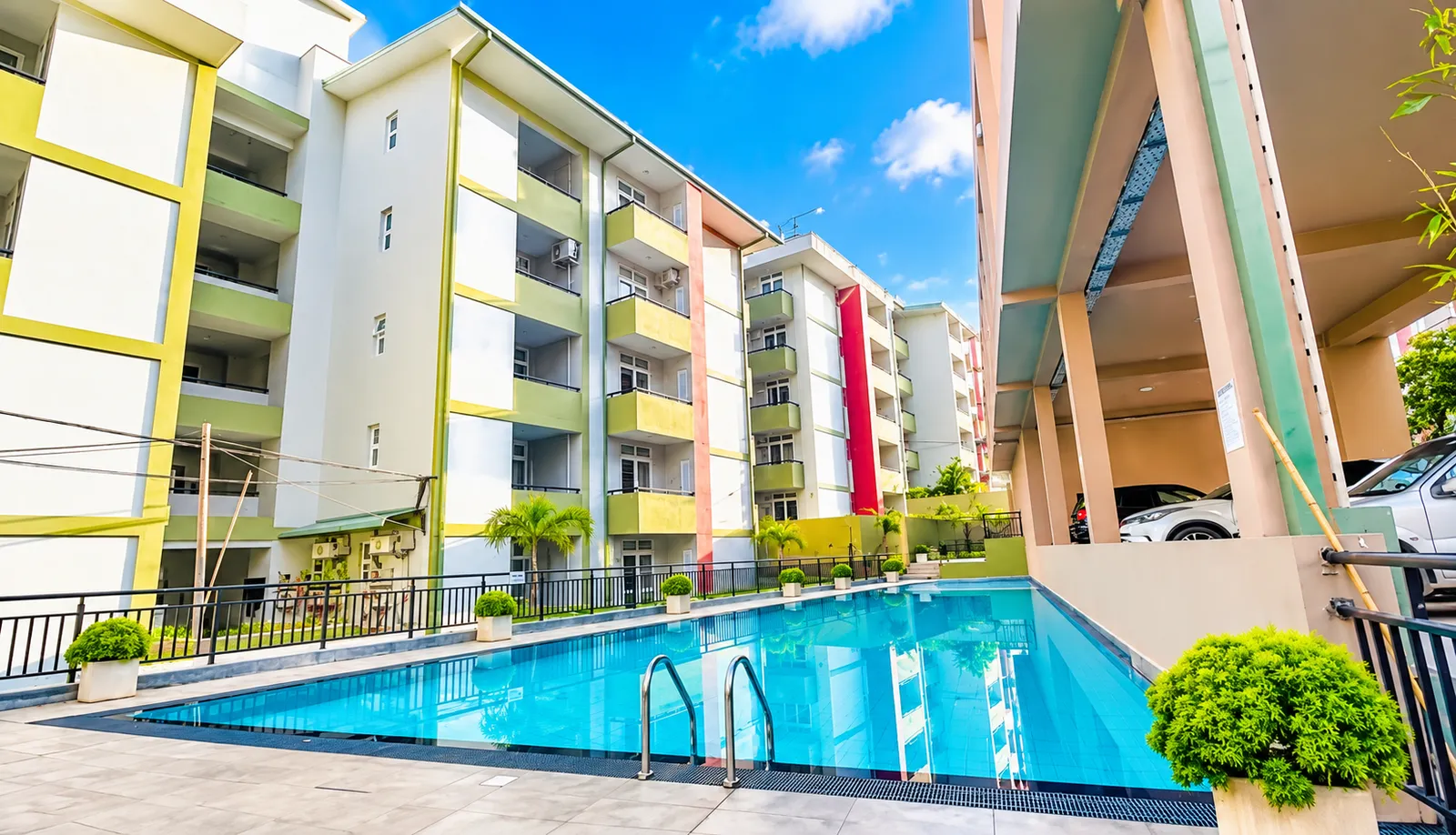 Shared swimming pool at Prime Residencies, surrounded by apartment buildings